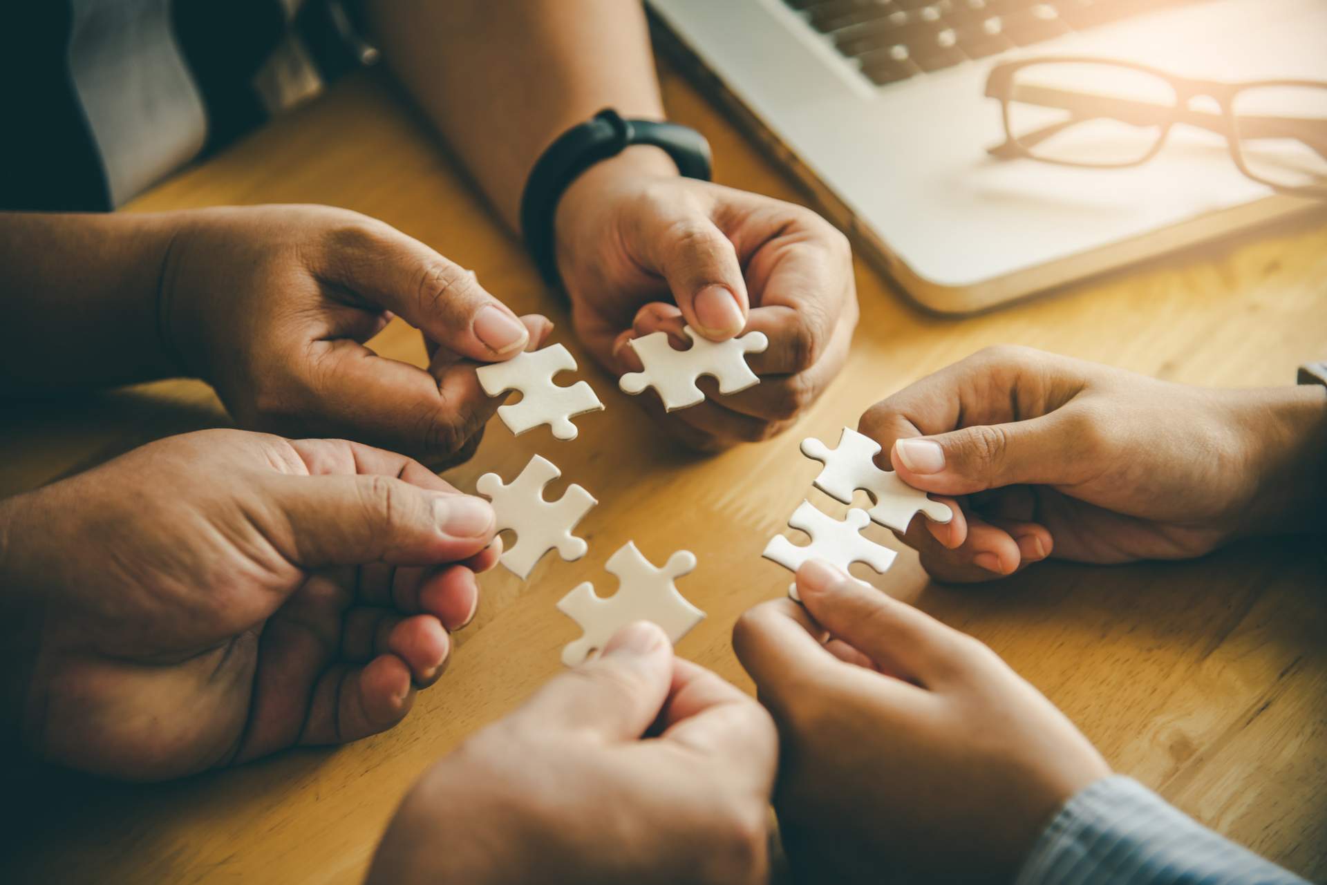 Business people holding puzzle pieces