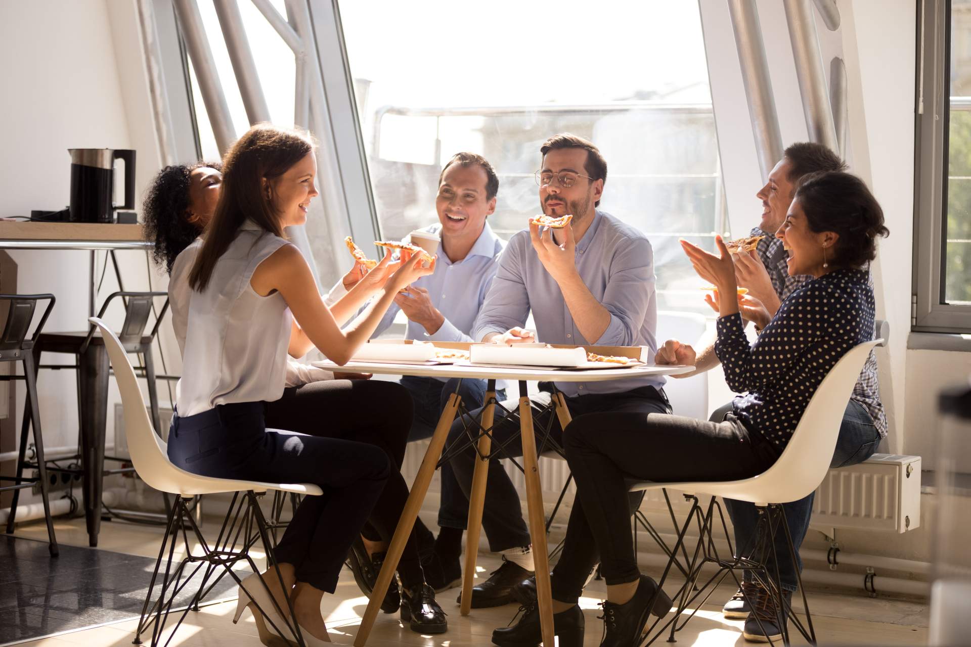 Group of young business people sitting at a table having a discussion